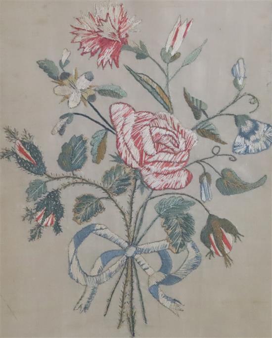 A pair of Regency silkwork panels of floral sprays, eglomise framed
